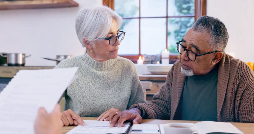 elderly couple reviewing will and trust documents