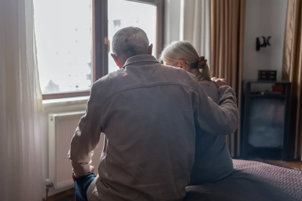 elderly couple embracing