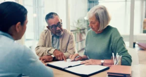 elderly couple reviewing documents