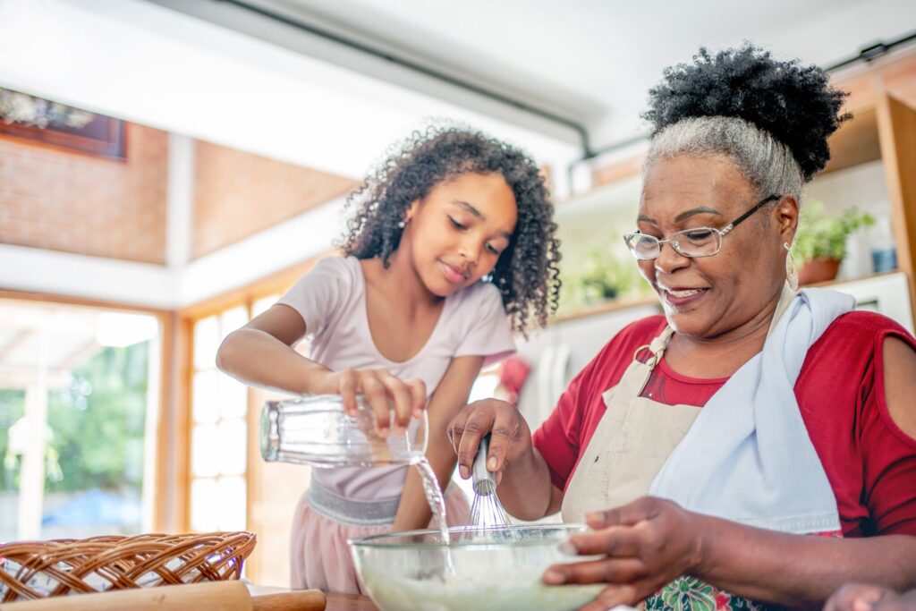 grandmother granddaughter baking together